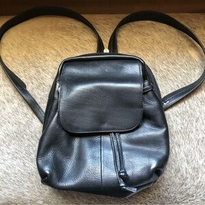 Piel black leather drawstring and flap backpack strap zips to one strap or two